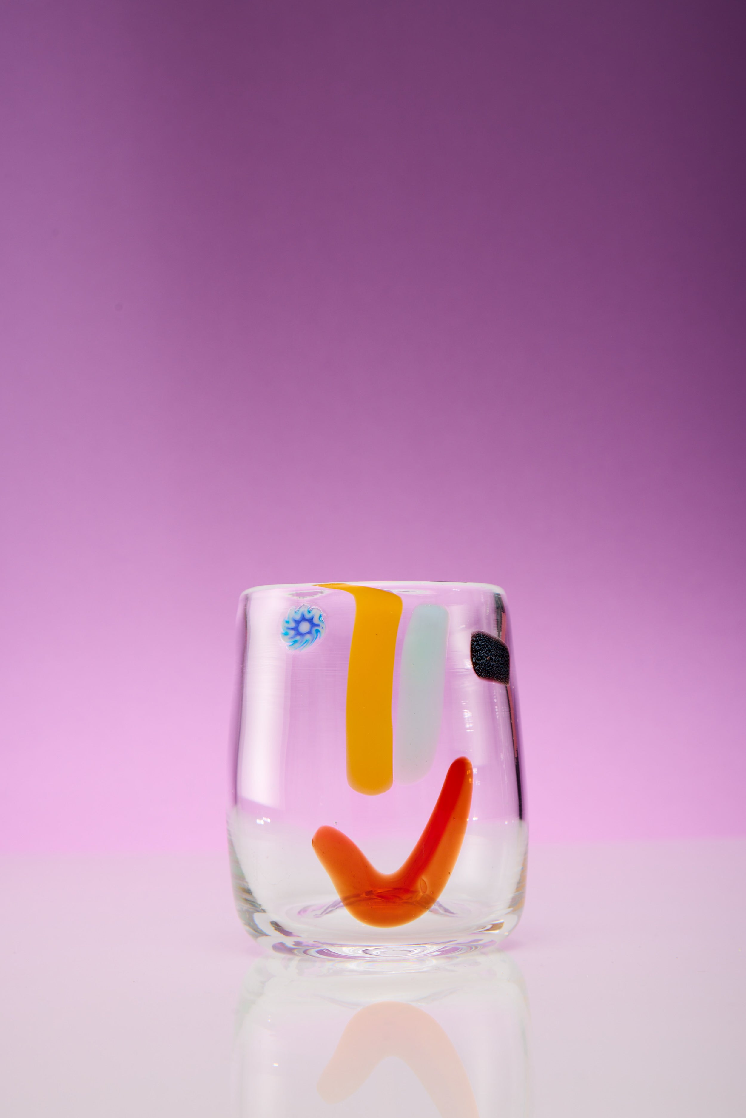 A single face vessel glass cup.