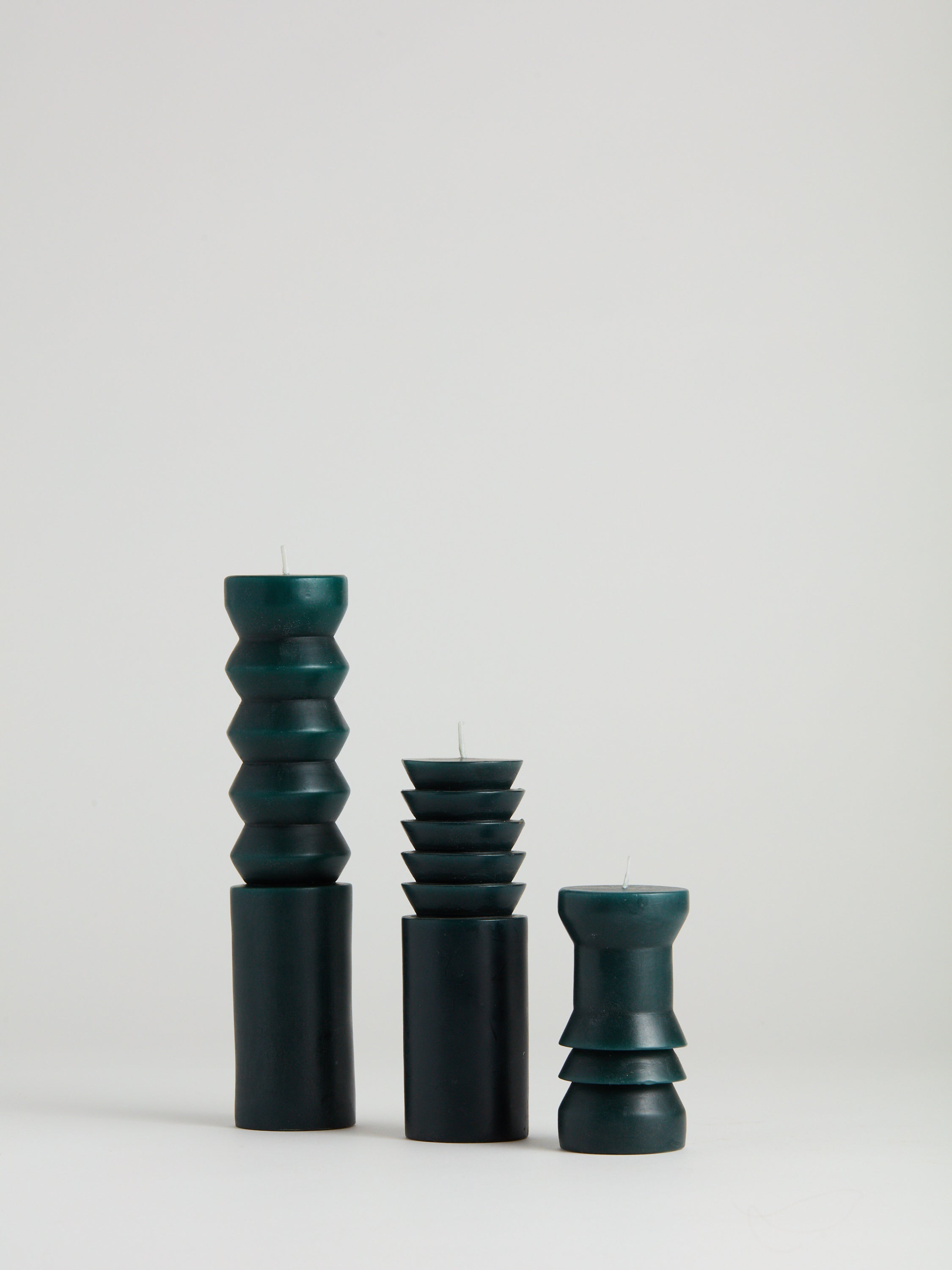 Dark green Totem Candles in small, mediu, and large.