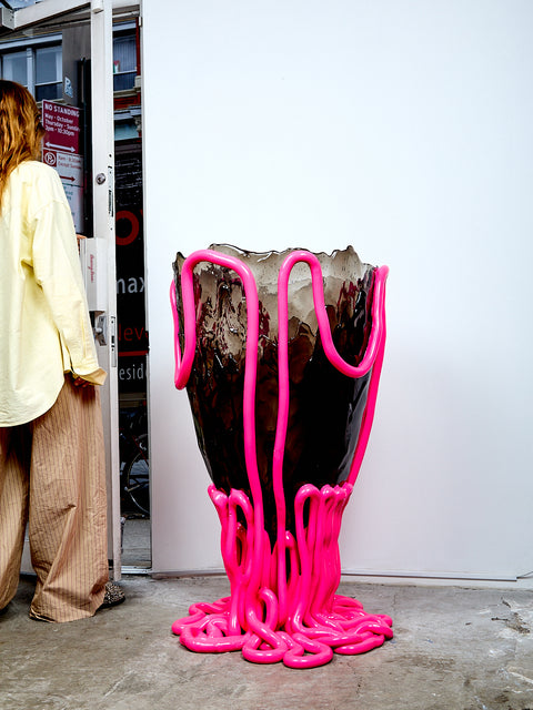 Large vase with pink liquid-like design on a white background