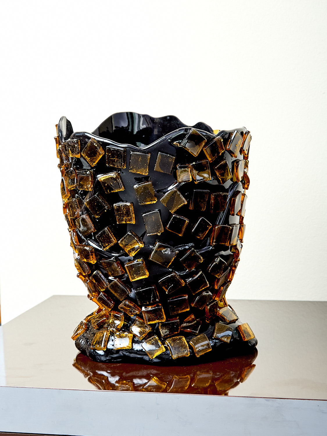 Decorative resin vase with mosaic tile design.