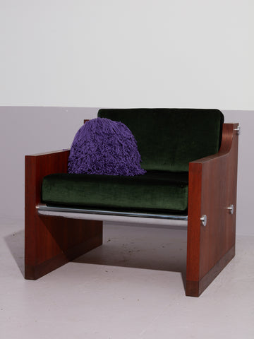 Purple Crochet Pillow by Huldra of Norway on an armchair.